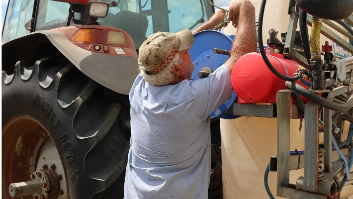 Man showing fire ant treatment equipment